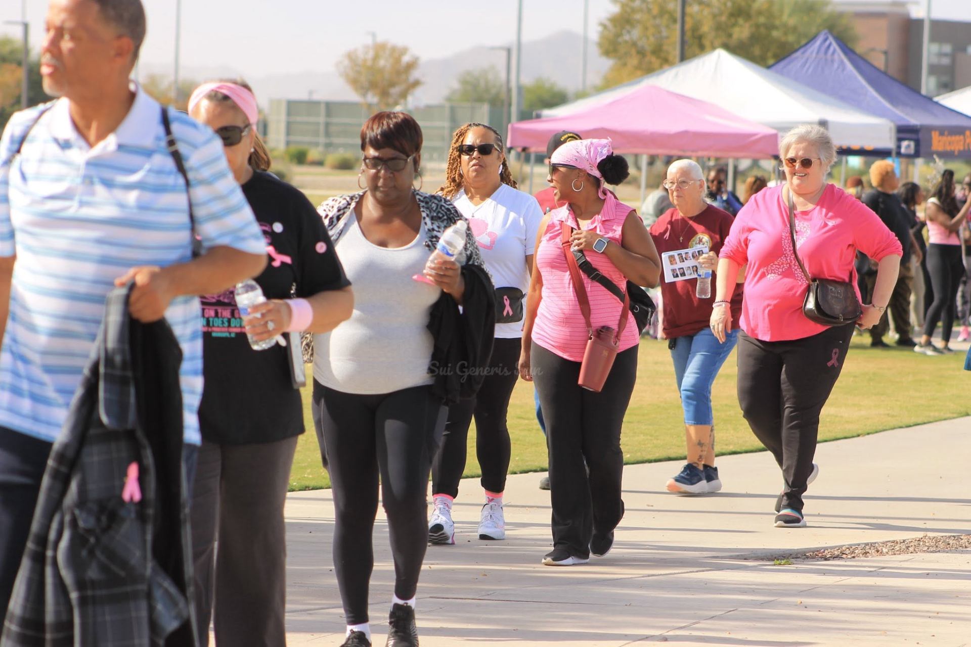 Walk participants embracing at sunrise