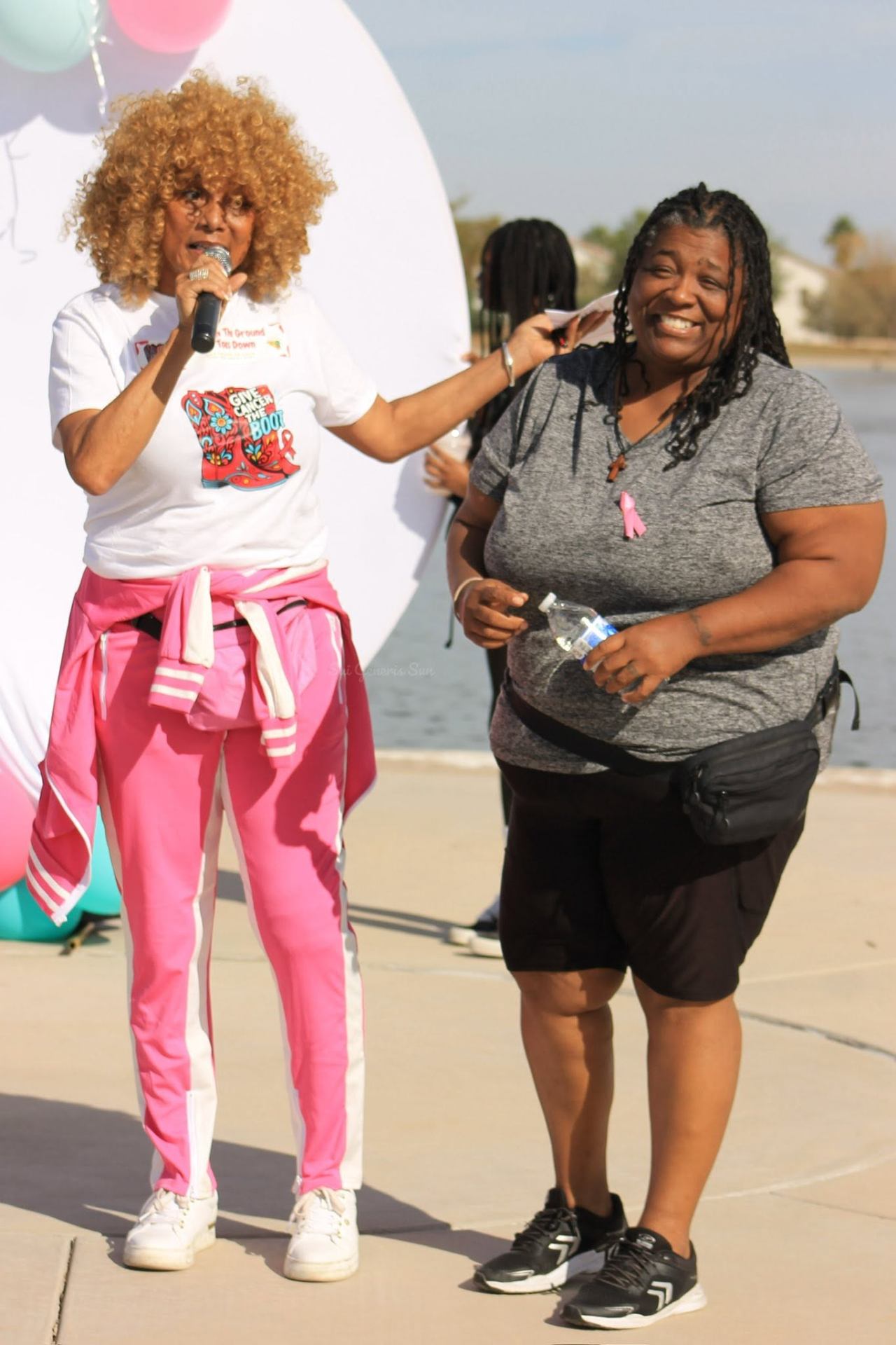 Event host on the mic in pink
